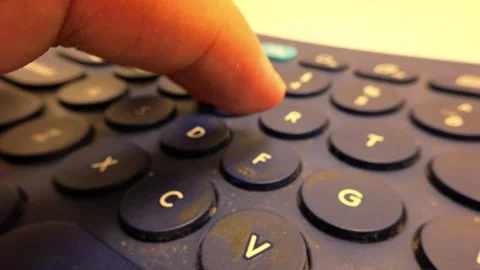 Close-Up Slow Motion Footage of Typing Words on a Bluetooth Keyboard Stock Footage 319513012