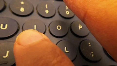 Close-Up Slow Motion Footage of Typing the Word 'Good' on a Bluetooth Keyboard Stock Footage 319513087