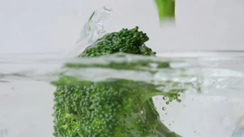 Close up slow motion of fresh broccoli splash in water Stock Footage 147673646
