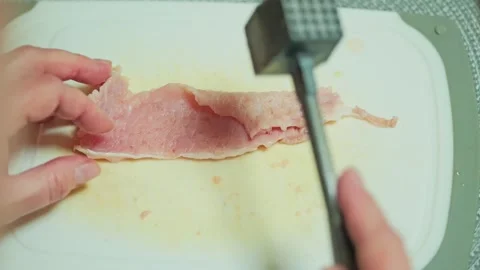 Close-Up Slow Motion of Fresh Meat Prepared for Tenderizing in Home Kitchen Stock Footage 340859030