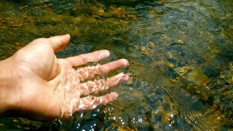 Close up slow motion Hand scooping fresh water in pure mountain spring Curren Stock Footage 270319628