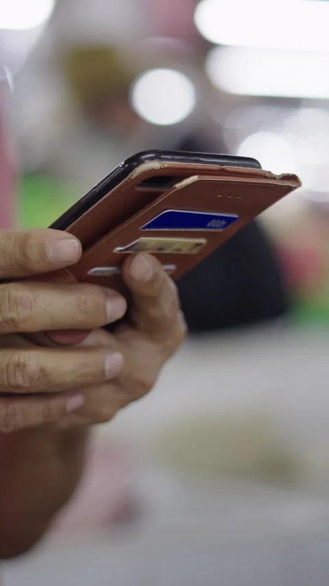 Close-up slow motion hands of a mature Asian man manipulating the screen of his Stock Footage 279950251