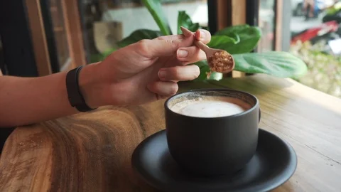 Close up Slow Motion of Hands Pouring Brown Sugar to The Coffee with Foam Stock Footage 109132499