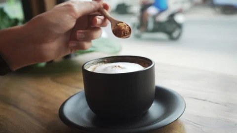 Close up Slow Motion of Hands Pouring Brown Sugar to The Coffee with Foam Stock Footage 109132673