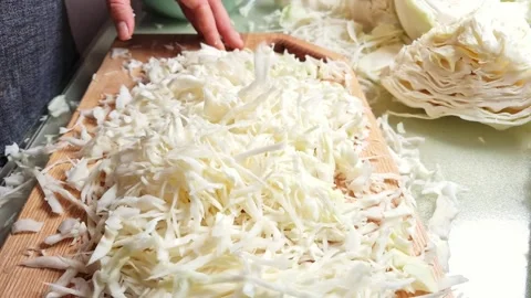 Close-up slow motion of hands slicing fresh cabbage on wooden board Stock Footage 341934919