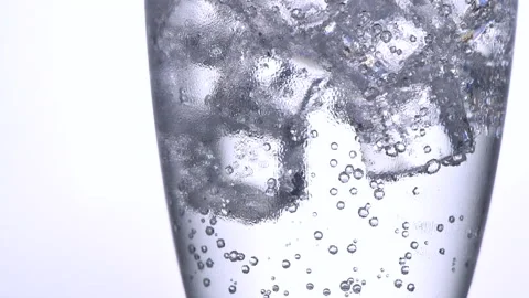 Close up slow motion ice cubes  with bubbles soda in glass Stock Footage 169594054