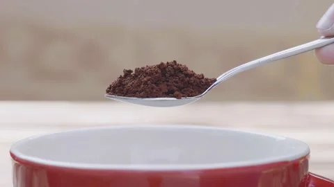 Close-up, slow-motion instant coffee that falls from the brewing spoon into the  Stock Footage 148746576