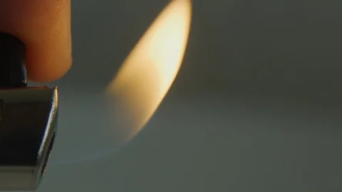 Close-up in slow motion of a lighter with flame being turned off Stock Footage 117626049