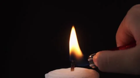 Close up slow motion of lighting a candle with a gas lighter Stock Footage 278958183
