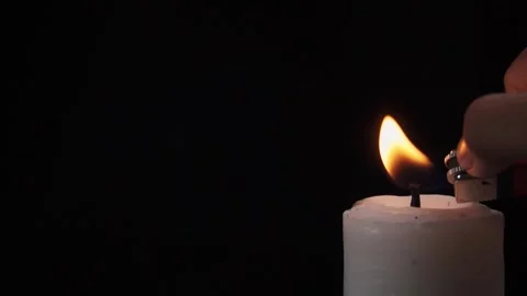 Close up slow motion of lighting a candle in corner with a gas lighter Stock Footage 279039828