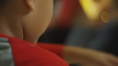 Close-up in slow motion of a little boy with parents in the background Stock Footage 88456555