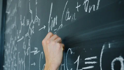 Close-up slow motion of maths student writing formulas on blackboard indoors Stock Footage 125026456