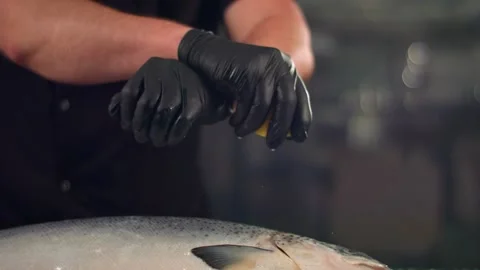 Close-up slow motion of a men hands chef, squeezing fresh lemon making juice on Stock Footage 137318438