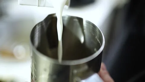 Close-Up Slow Motion Milk Pouring into Pitcher Stock Footage 312261457