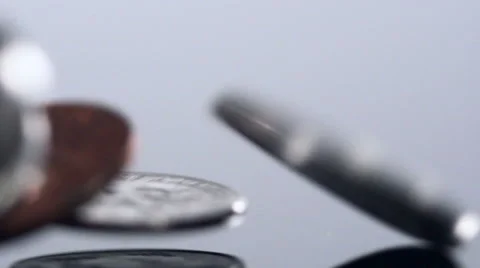 Close up in slow motion of mixed American coins dropping onto a hard surface. Stock Footage 55621684