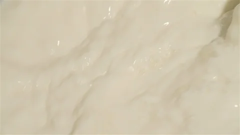 Close-up Slow Motion of Mixing Milk in a Machine Video stock 128965883