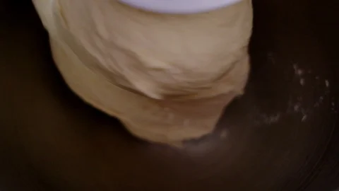 Close up of slow motion mixing white dough in bowl with electric mixer, bakin Stock Footage 129409209