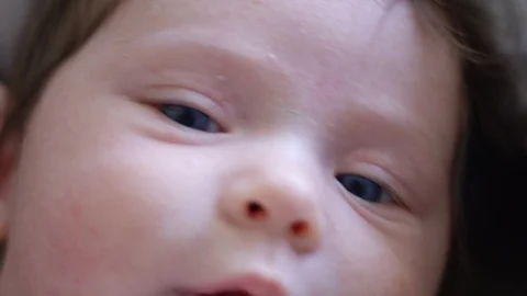 Close-up in slow motion of a one-month old baby Stock Footage 107617234