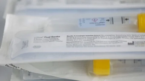 Close Up Slow Motion Pan of a Pile of COVID Swabs and Tubes Stock Footage 129415865