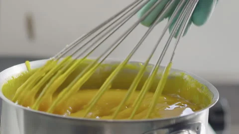 Close-up, Slow Motion, Pastry Hand in Glove Stirs Boiling On The Plate Cream Stock Footage 136801186
