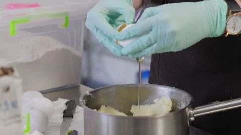 Close-up, Slow Motion, Pastry Hands in Gloves Break Egg for Making Cream for Stock Footage 136799626