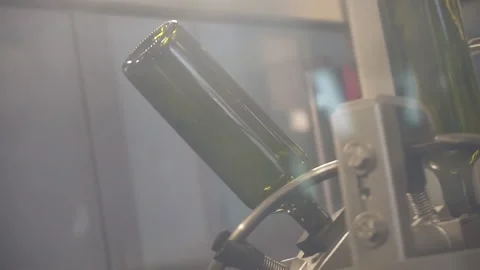 Close-up, slow-motion picture of the movement of the bottle on the conveyor. Stock Footage 155425569