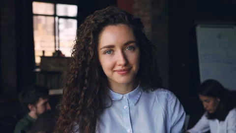 Close-up slow motion portrait of cheerful young lady business owner standing in Stock Footage 93080933