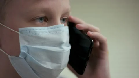 A close up slow motion portrait of a young blonde caucasian guy in a surgical Stock Footage 134424013