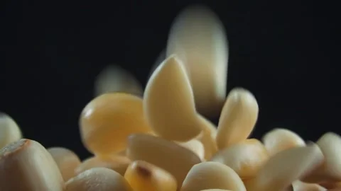 Close up slow motion of pouring garlic into wooden bowl Stock Footage 279526484