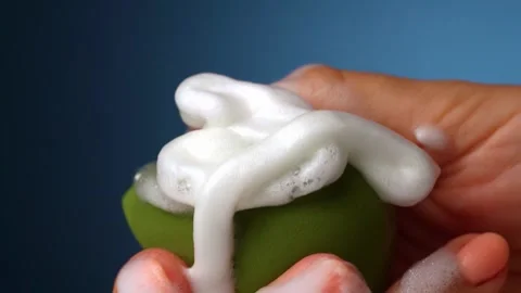 Close up slow motion of pouring liquid foam on makeup foundation on makeup Stock Footage 245004631