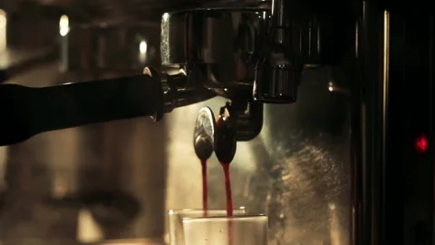 Close-up Slow motion of prepares espresso pouring from coffee machine Видео 138849759