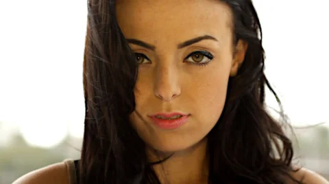 Close up slow motion on pretty face of young woman Stock Footage 27499433