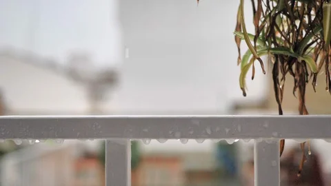 Close-up of slow motion rain water drops on white steel grating Stock Footage 128540457