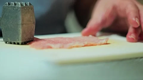 Close-Up Slow Motion of Raw Meat Being Flattened for Traditional Homemade Recipe Stock Footage 340859055