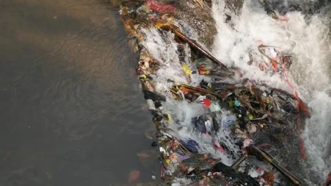 Close up slow motion of river rapids contrasting against plastic trash. Stock Footage 336322777