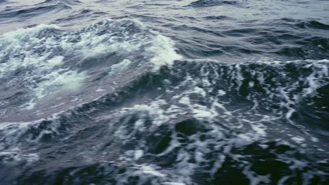 Close up with slow motion sea splash waves from sailing yacht. Dark sea waves. Stock Footage 218203222