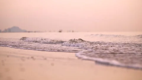 Close up slow motion of sea wave wash sandy beach at sunset 스톡 동영상 320535915