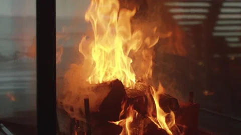 Close up slow motion shot around a roaring fire in the middle of an empty room Stock Footage 146289838
