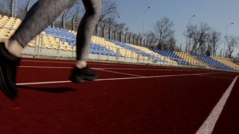 Close up slow motion shot of athletic woman running jogging workout on sunny day Stock Footage 137542817