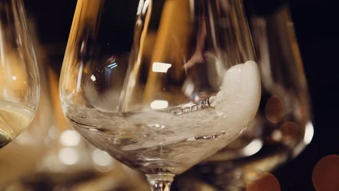 Close up slow motion shot, bartender, waiter pouring glass with Champagne. Stock Footage 120841374