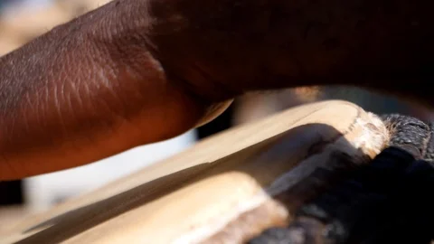 Close slow motion shot of black man playing djembe with plaster on finger Stock Footage 113167127