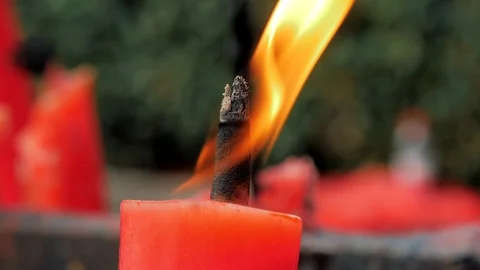 Close-up slow motion shot of a candle burning in a Buddhist temple., China. Stock Footage 119197191
