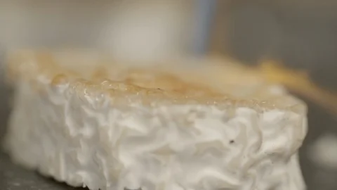 Close-up slow motion shot of caramelizing goat cheese slice in kitchen - Paris, Stock Footage 129203794