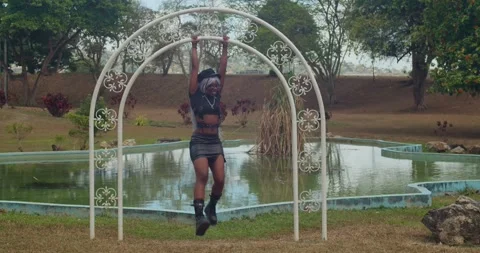 Close-up slow-motion shot of a dark-skinned woman in a stylish leather outfit Видео 336650014