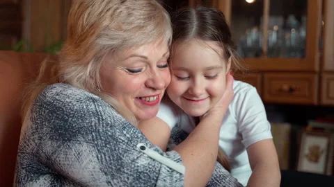 Close up slow motion shot elderly woman shows little girl family album Stock Footage 152828632