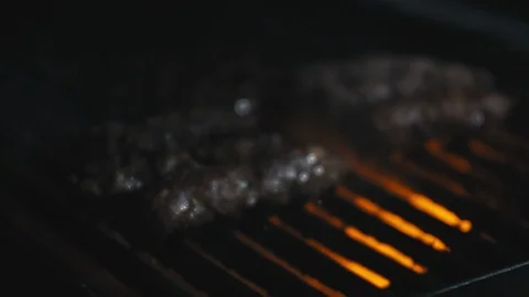 Close-up slow motion shot of fire bursting in a barbeque Stock Footage 113267121