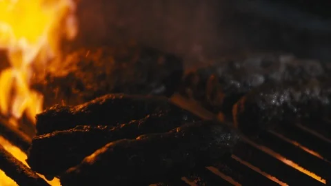 Close-up slow motion shot of fire bursting in a barbeque Stock Footage 113267123