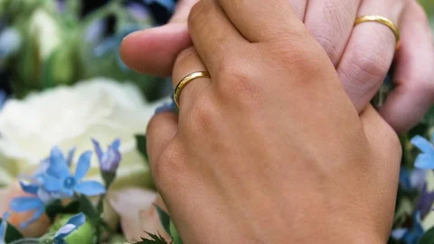 Close slow motion shot of the hands of a married couple with the wedding Stock Footage 120719921