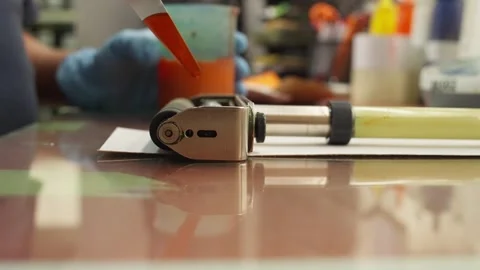 CLOSE UP SLOW MOTION SHOT OF AN INK TEST AT A INK WORKSHOP Stock Footage 328138375