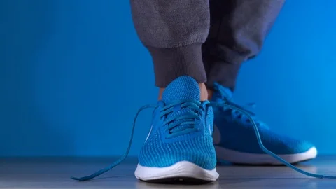 Close up slow motion shot of legs Composition with sport shoes Man tying sports Stock-Footage 101177236